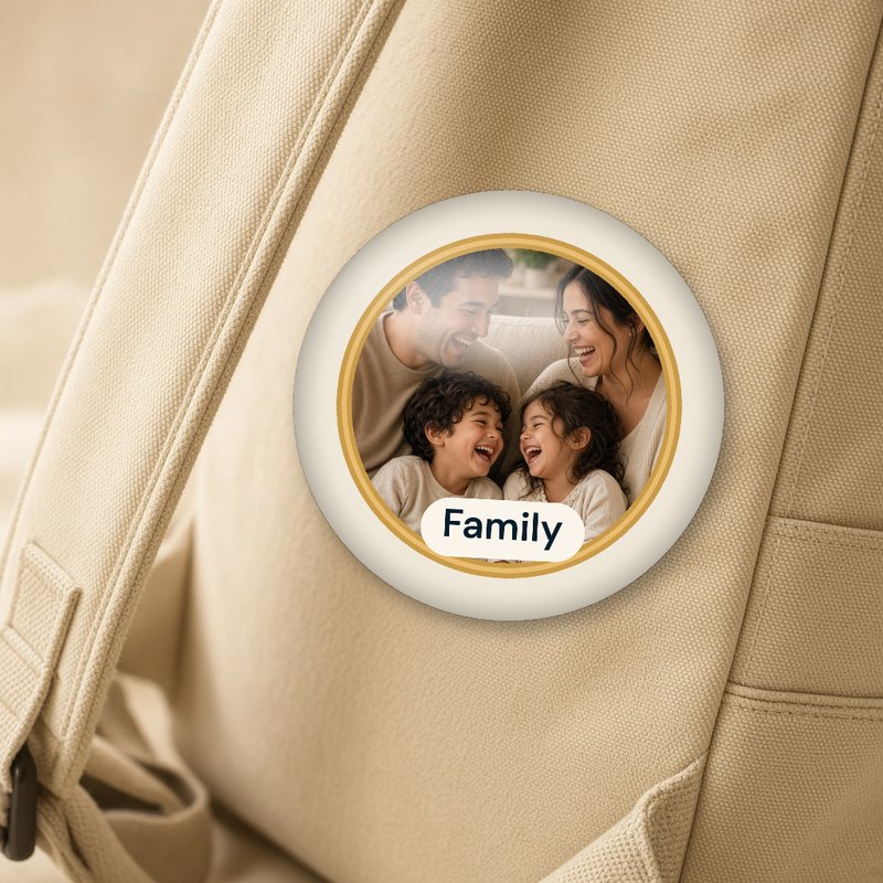 A round button pin showing one glass circle with a gold rim, the label Family and a family photo inside.